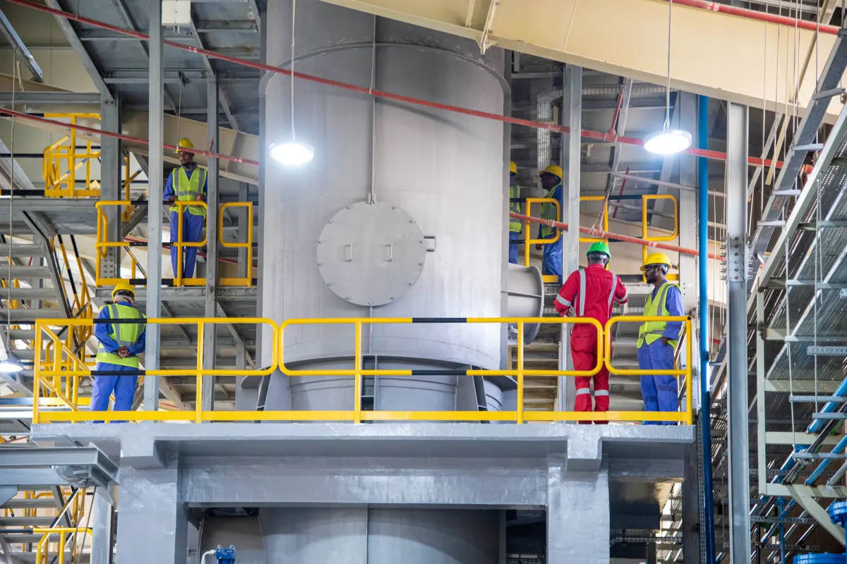 Seashore operations team working in full personal protective equipment on the plant platform